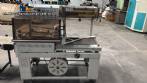 Automatic L-sealer with shrink tunnel.