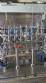 Complete filling line with Tecman Nelpas Tecnoenvase Tudela bottle filling, labeling, capping, and positioning machines for cosmetic liquids.