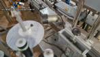Automatic double-head labeling machine for cylindrical and flat bottles, Tudela, 3,000 labels per hour.