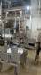 Labeling machine with steam sleeve tunnel and bottle baler