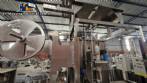 Labeling machine with steam sleeve tunnel and bottle baler