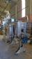 Labeling machine with steam sleeve tunnel and bottle baler