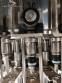 Zegla rotary filling machine with rinser and three-block capping system.