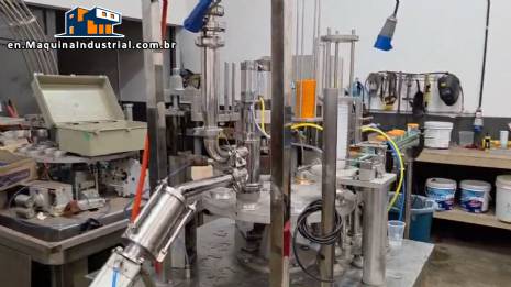 Rotary filling and dosing machine with capping and sealing unit for cups and bottles, capacity 2,000 units. Rotary filling and dosing machine with capping and sealing unit for cups and bottles, capacity 2,000 units.